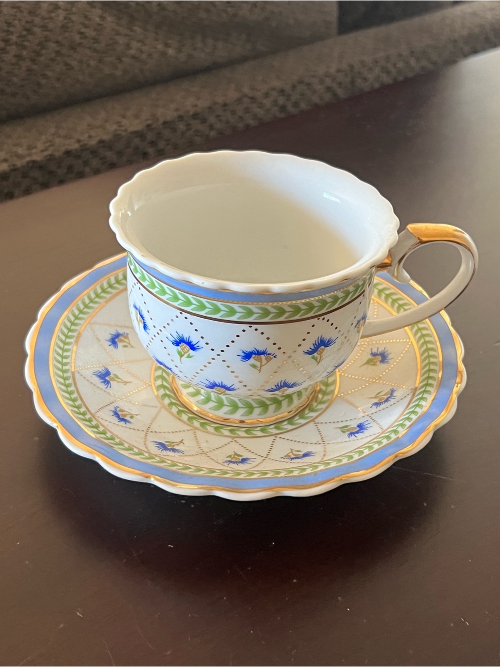 Fine Porcelain Teacup and Saucer in White with Blue Floral and Gold Trim